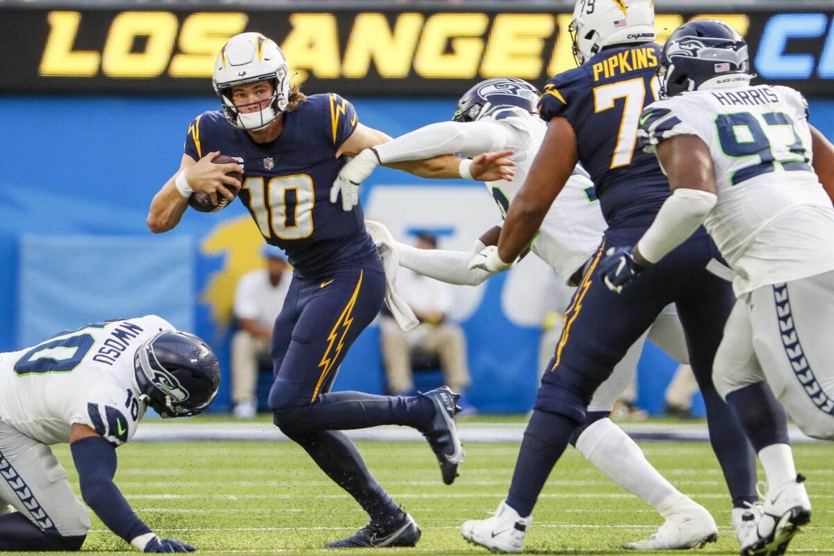 Chargers quarterback Justin Herbert escapes pressure during a drive against the Seattle Seahawks.
