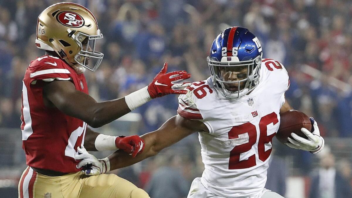 New York Giants running back Saquon Barkley tries to get past San Francisco's Jimmie Ward on Nov. 12 at Levi's Stadium.