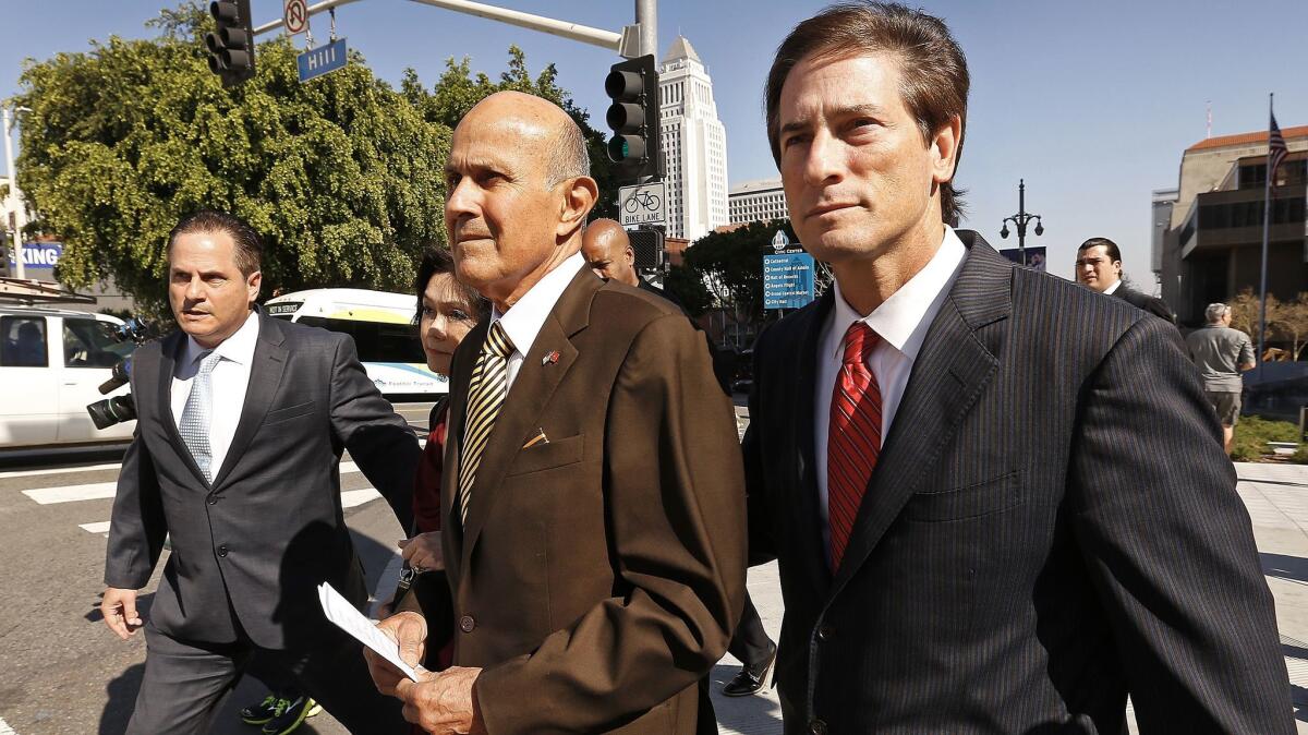 Former Los Angeles County Sheriff Lee Baca with his attorney Nathan Hochman at his side departs the Los Angeles Federal Courthouse after he was found guilty of obstructing a federal investigation into abuses in county jails and lying to cover up the interference.