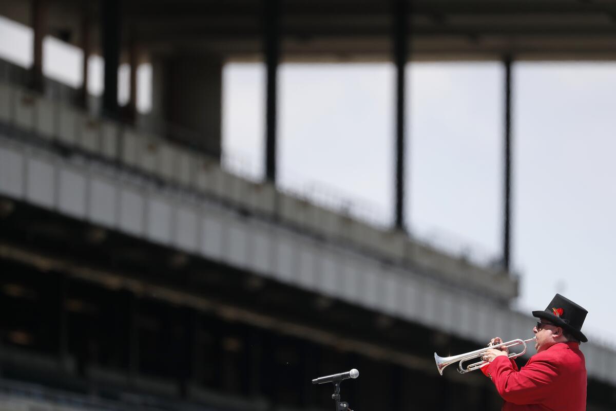 Sam Grossman plays to an empty grandstand before the 152nd Belmont Stakes in Elmont, N.Y. on Saturday.