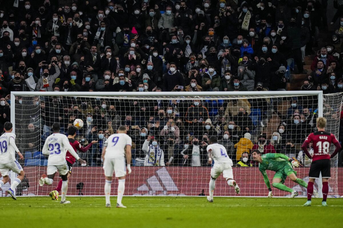 Valencia's Goncalo Guedes, left, scores after a penalty shoot during the La Liga soccer match between Real Madrid and Valencia at Santiago Bernabeu stadium in Madrid, Spain, Saturday, Jan. 8, 2022. (AP Photo/Bernat Armangue)