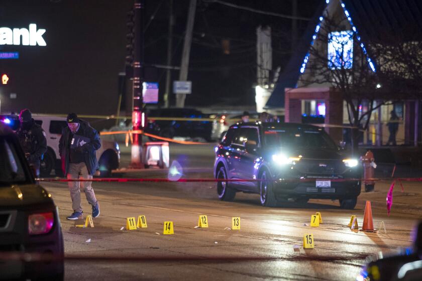 Chicago and Evanston police investigate a crime scene after a gunman went on a shooting spree before being killed by police during a shootout in Evanston, Ill., Saturday night, Jan. 9, 2021. (Ashlee Rezin Garcia/Chicago Sun-Times via AP)