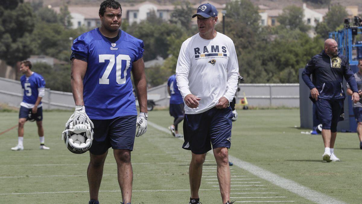 Rams rookie offensive lineman Joseph Noteboom talks with coach Aaron Kromer during practice at Cal Lutheran University on June 4.