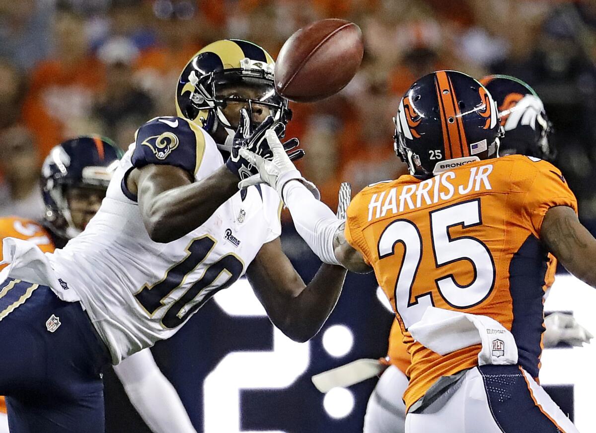 Rams receiver Pharoh Cooper (10) makes a catch as Denver Broncos cornerback Chris Harris (25) defends during the first half of a game at Denver on Saturday.