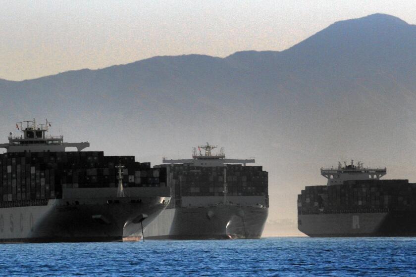 Economists and trade experts say a potential shutdown of 29 West Coast ports would have very little effect on the broader U.S. economy. Above, three container ships wait to dock this week at the ports in Long Beach and Los Angeles.