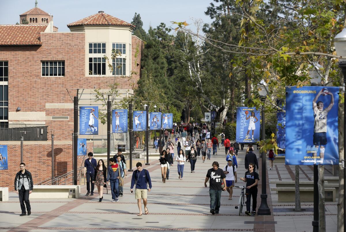 Alumnos caminan por el campus de UCLA, en Westwood, en 2015. Los sistemas de la Universidad de California y la Universidad Estatal de California fueron demandados esta semana por alumnos que exigen reembolsos de sus matrículas.