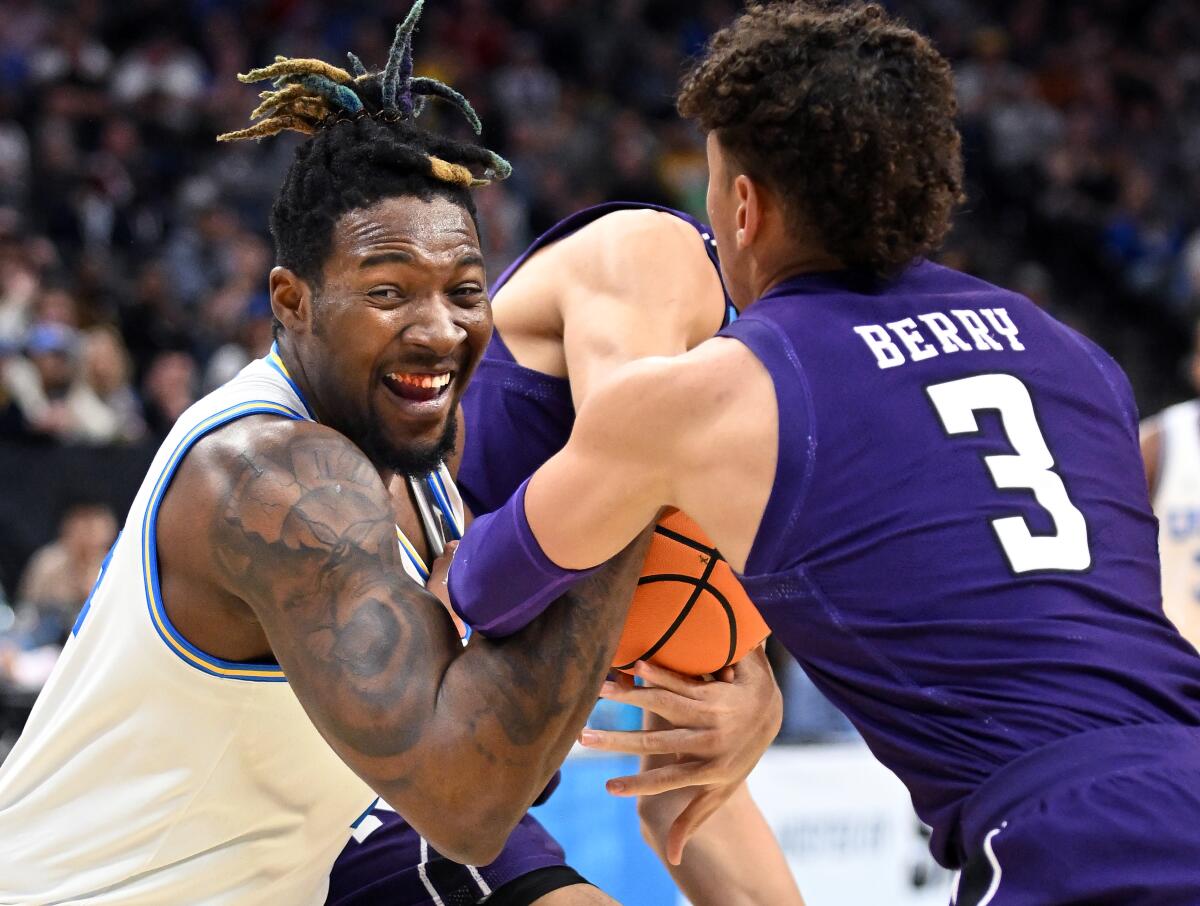 UCLA's Kenneth Nwuba battles for a loose ball against Northwestern's Ty Berry in the first half.