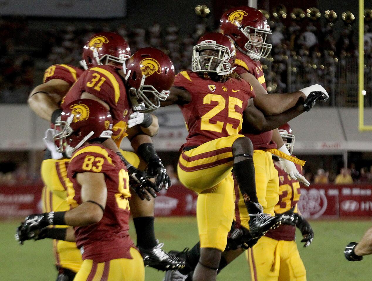 USC tailback Ronad Jones (25) celebrates with teammates after scoring a touchdown against Idaho in the fourth quarter on Saturday at the Coliseum.