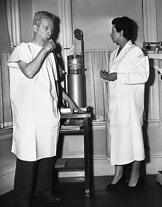 Technician Leone Coppola, right, conducts a test of Walter Sullivan at the Framingham, Mass., clinic on April 7, 1952.