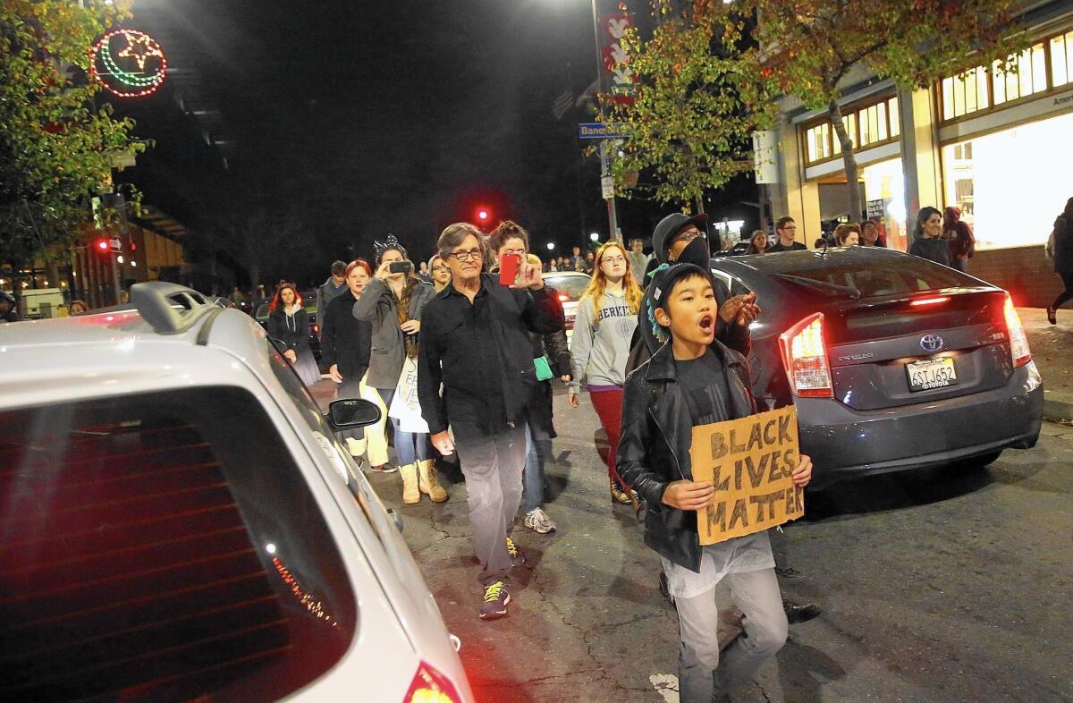 Demonstrators march through traffic on Telegraph Avenue in Berkeley on Wednesday night.