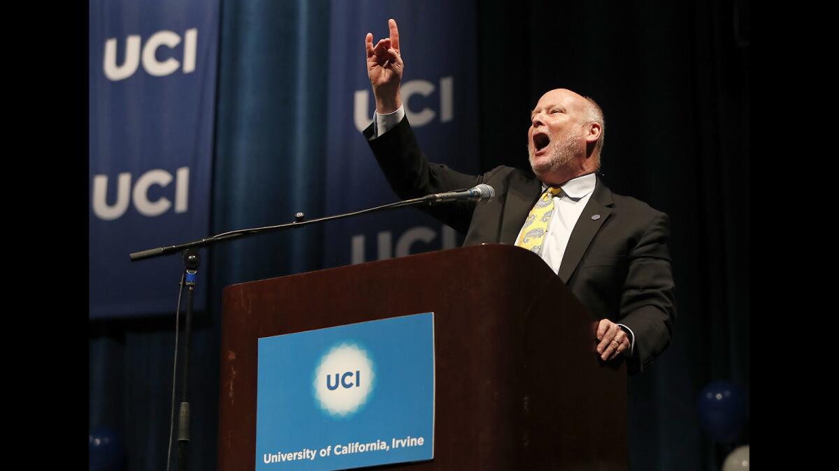 UC Irvine Chancellor Howard Gillman gives the "zot, zot, zot" hand signal during the 2019 College Signing Day rally in May at the university's Bren Events Center.
