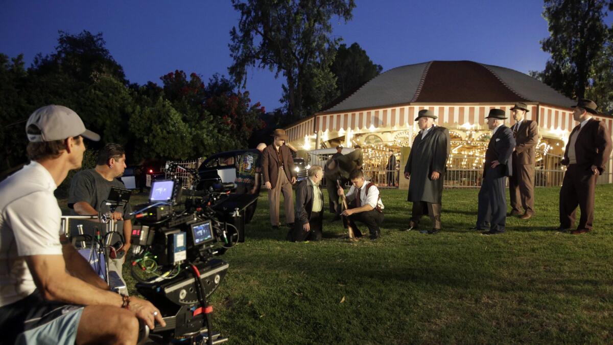 The crew and cast in the filming of the 1940s-set crime drama 'Mob City,' in Griffith Park in Los Angeles