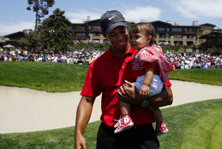 Tiger Woods holds his daughter Sam on the 18th hole after winning the U.S. Open at Torrey Pines in 2008.