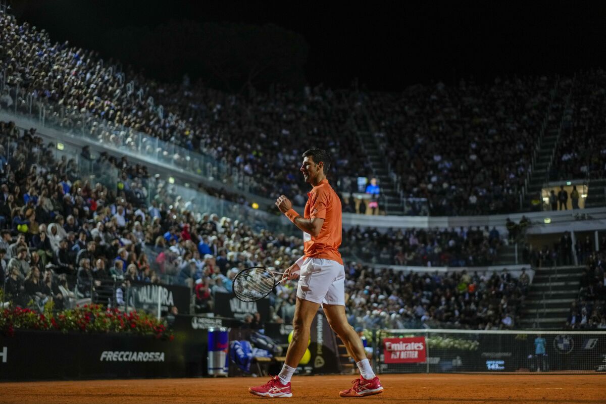 Novak Djokovic of Serbia celebrates after winning a point to Felix Auger-Aliassime of Canada during their match at the Italian Open tennis tournament, in Rome, Friday, May 13, 2022. (AP Photo/Andrew Medichini)
