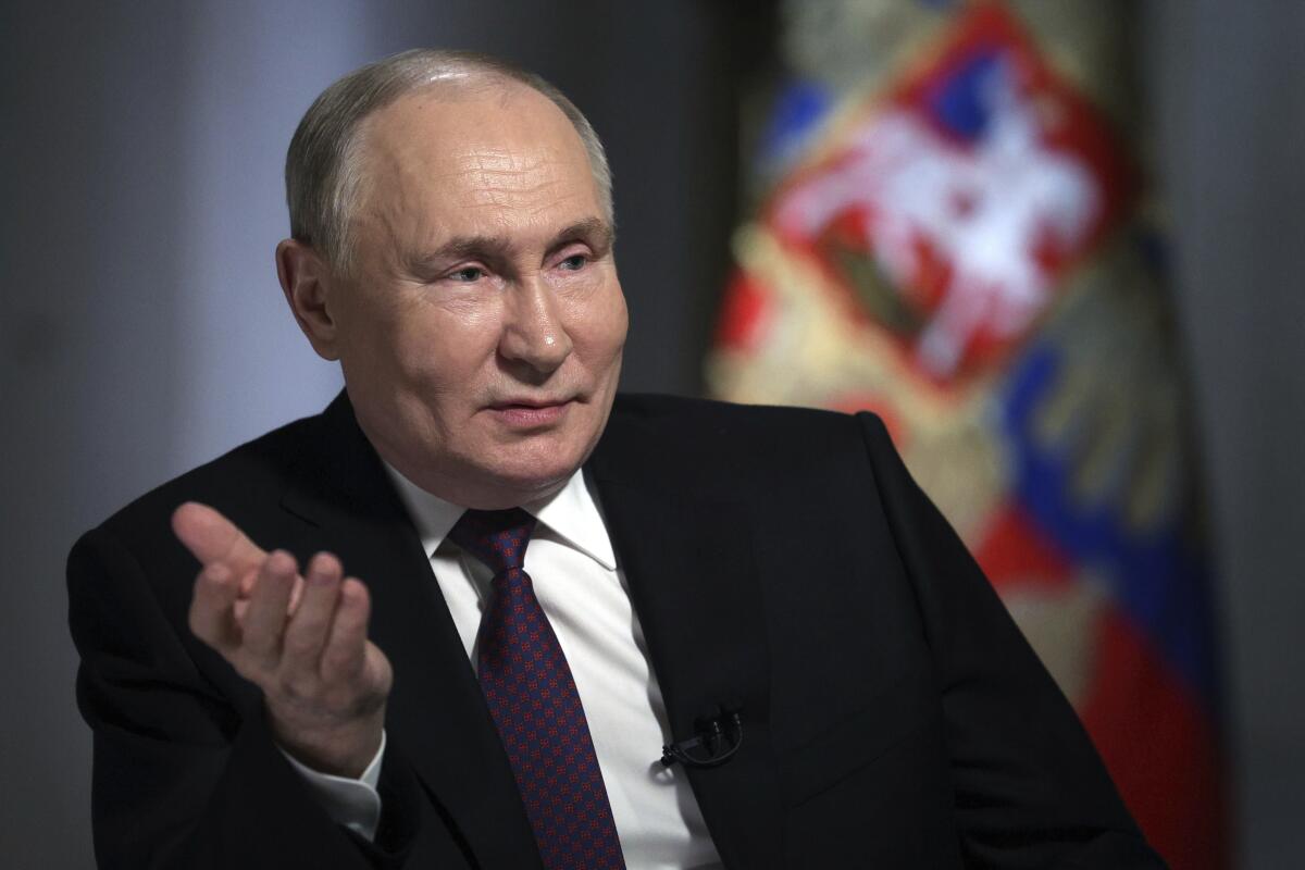 Russian President Vladimir Putin gestures during an interview.