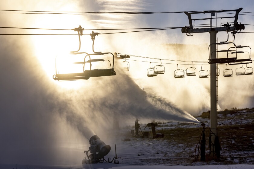 In this photo provided by Big Bear Mountain Resort, snowmaking operations are seen underway in preparation for the resort's opening in Big Bear Lake, Calif., on Nov. 26, 2021. Two Southern California ski areas will open this week despite dry fall weather. Big Bear Mountain Resorts announced that Friday, Dec. 3 will be opening day for the general public at Bear Mountain and Snow Summit. Season pass holders will get an early start on Thursday. (Jared Meyer/Big Bear Mountain Resort via AP)
