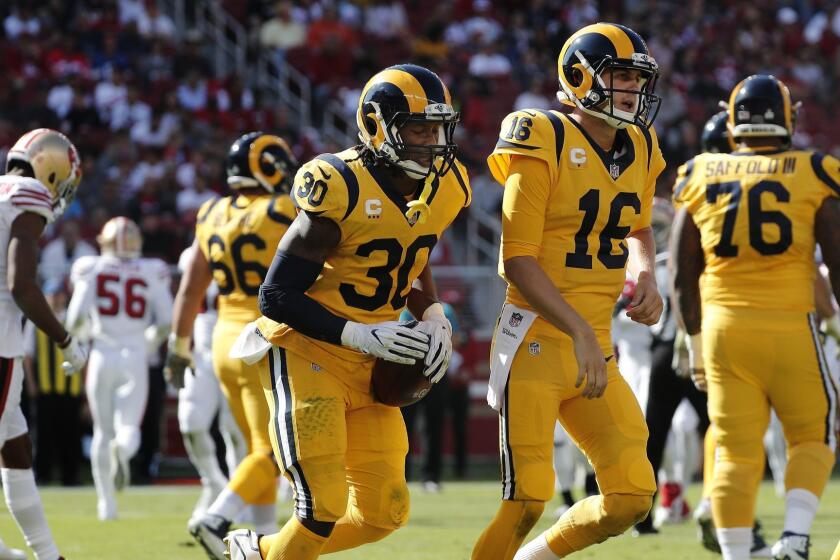 SANTA CLARA, CA - OCTOBER 21, 2018: Los Angeles Rams running back Todd Gurley (30) leaves the end zone with Los Angeles Rams quarterback Jared Goff (16) after scoring in the first half against the 49ers at Levi's Stadium on October 21, 2018 in Santa Clara, California.(Gina Ferazzi/Los AngelesTimes)