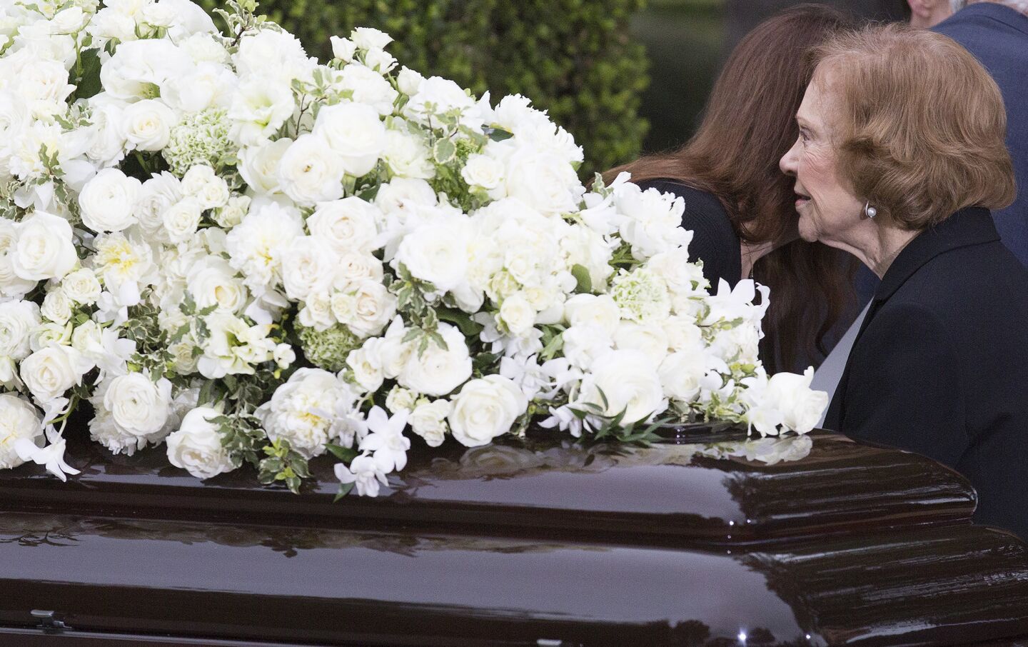 Former First Lady Rosalynn Carter pauses at Nancy Reagan's casket at the Ronald Reagan Presidential Library in Simi Valley.