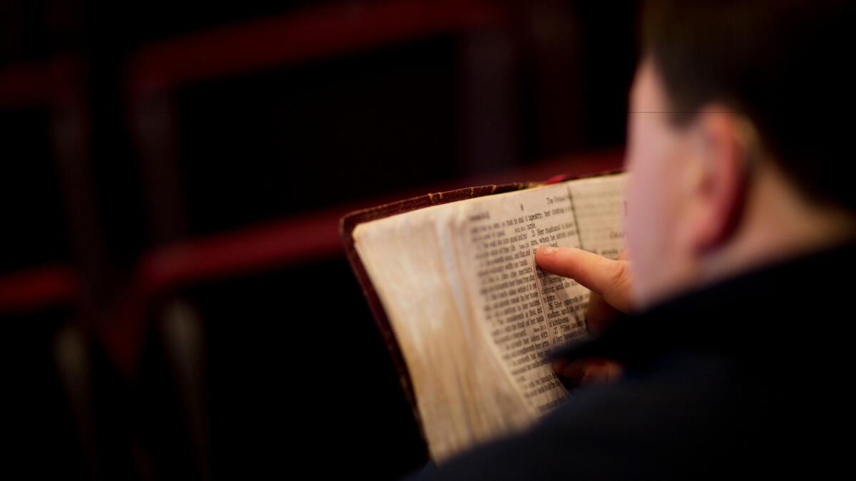 A parishioner reads the bible before a service at the Christian Fellowship Church in Benton, Ky. on April 10.