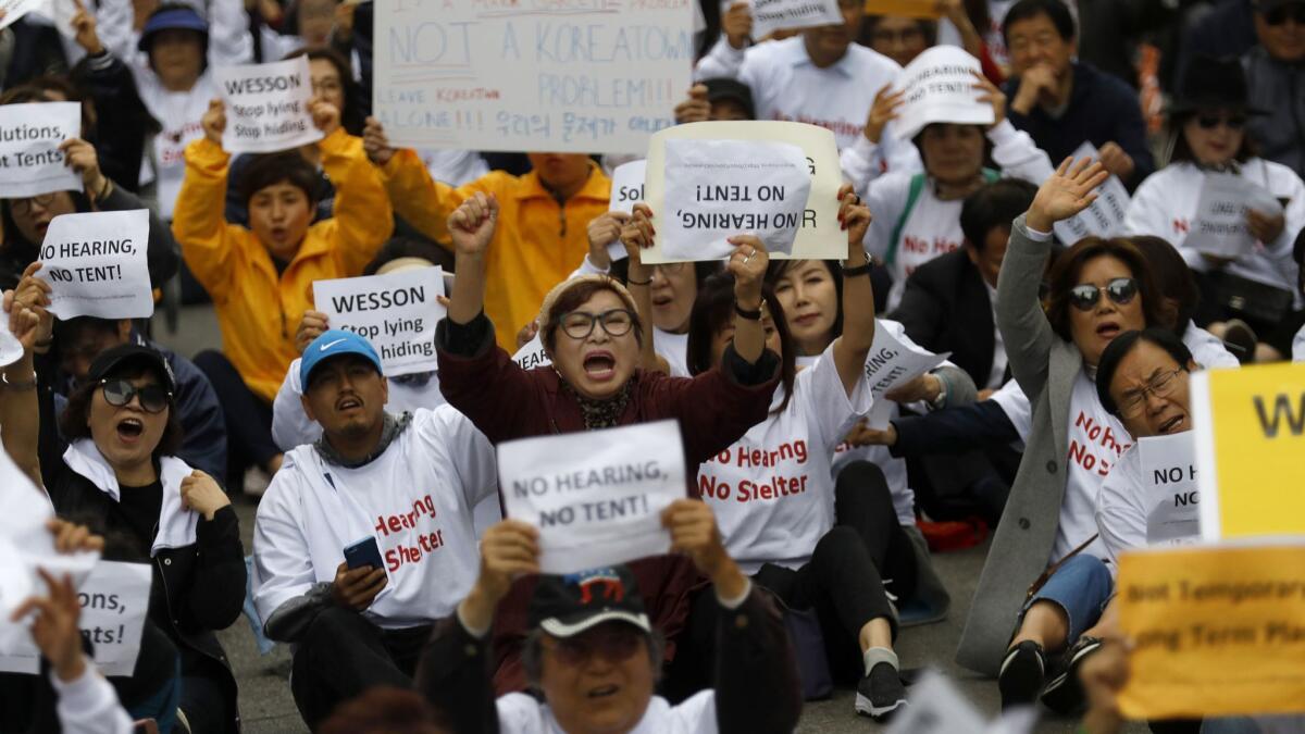 Protesters march down Wilshire Boulevard in May to oppose temporary homeless housing planned for Koreatown. The initial plan was eventually scrapped and replaced with an alternative site about half a mile away.