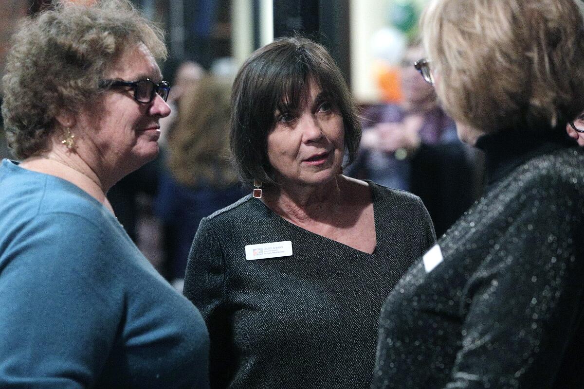 Judith Arandes, executive director of the Burbank Housing Corp., talks with colleagues at her retirement party at Gordon Biersch in Burbank on Thursday. Arandes is retiring after 21 years of community service.