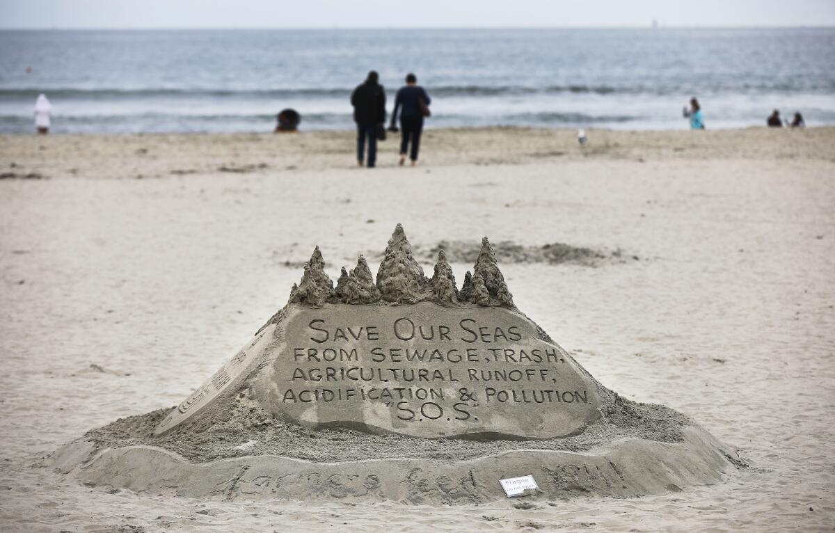A sand sculpture in Coronado has a message for clean water on Dec. 29, 2019.