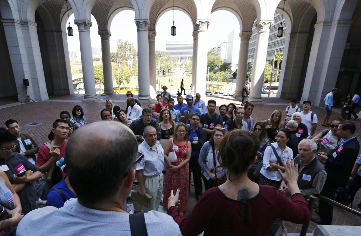 Airbnb hosts gather at City Hall before a Los Angeles City Planning Commission meeting in June to consider new regulations on Airbnb and other short-term rental sites.