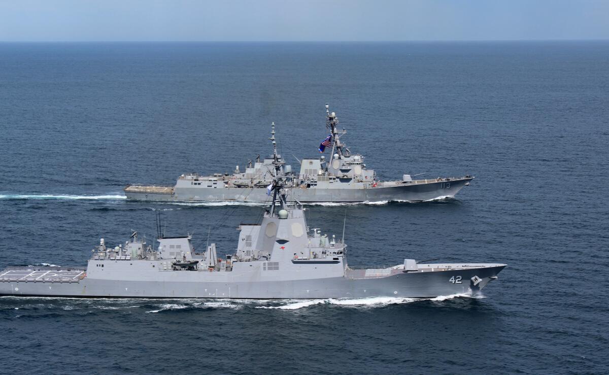 Two warships at sea.