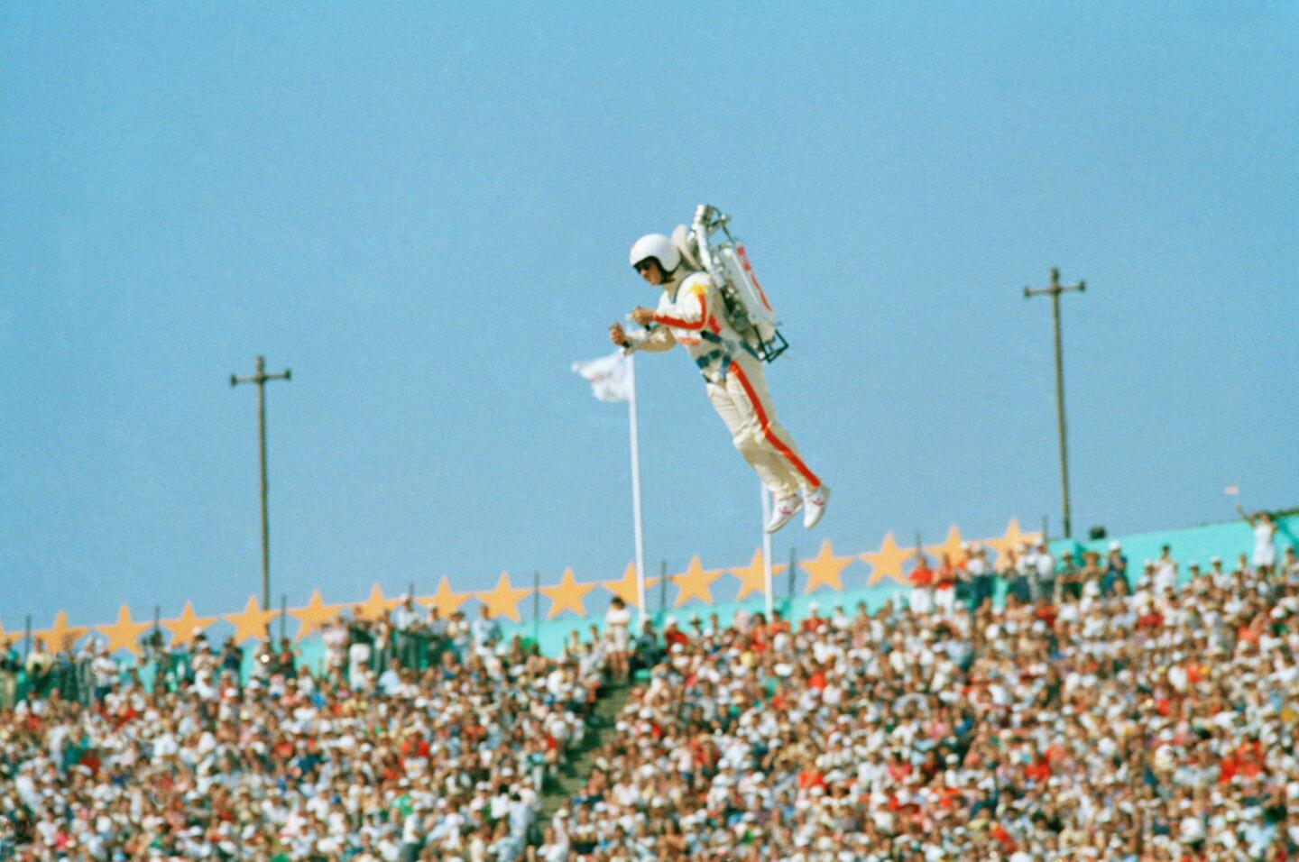 Bill Suitor, a.k.a. Rocket Man, soars with the help of a jet pack July 28, 1984, during the welcoming of nations at the opening ceremony of the 1984 Summer Olympics in the Los Angeles Memorial Coliseum.