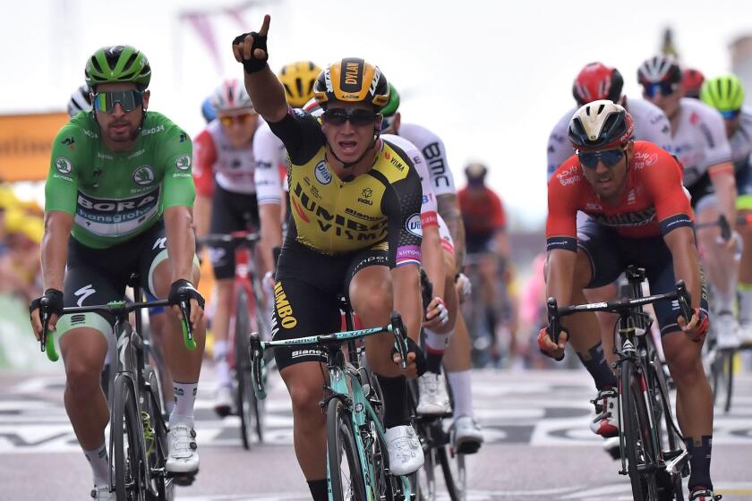 TOPSHOT - Netherlands' Dylan Groenewegen (C) celebrates as he wins on the finish line of the seventh stage of the 106th edition of the Tour de France cycling race between Belfort and Chalon-sur-Saone, in Chalon-sur-Saone, eastern France, on July 12, 2019. (Photo by Marco Bertorello / AFP)MARCO BERTORELLO/AFP/Getty Images ** OUTS - ELSENT, FPG, CM - OUTS * NM, PH, VA if sourced by CT, LA or MoD **