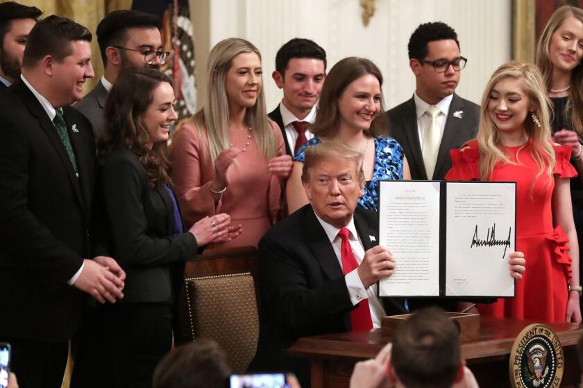 WASHINGTON, DC - MARCH 21: U.S. President Donald Trump holds up an executive order he signed protecting freedom of speech on college campuses during a ceremony in the East Room at the White House March 21, 2019 in Washington, DC. Surrounded by student who have said their conservative views are suppressed at universities across the country, Trump signed the order improving free inquiry, transparency, and accountability on campus, according to the White House. (Photo by Chip Somodevilla/Getty Images) ** OUTS - ELSENT, FPG, CM - OUTS * NM, PH, VA if sourced by CT, LA or MoD **