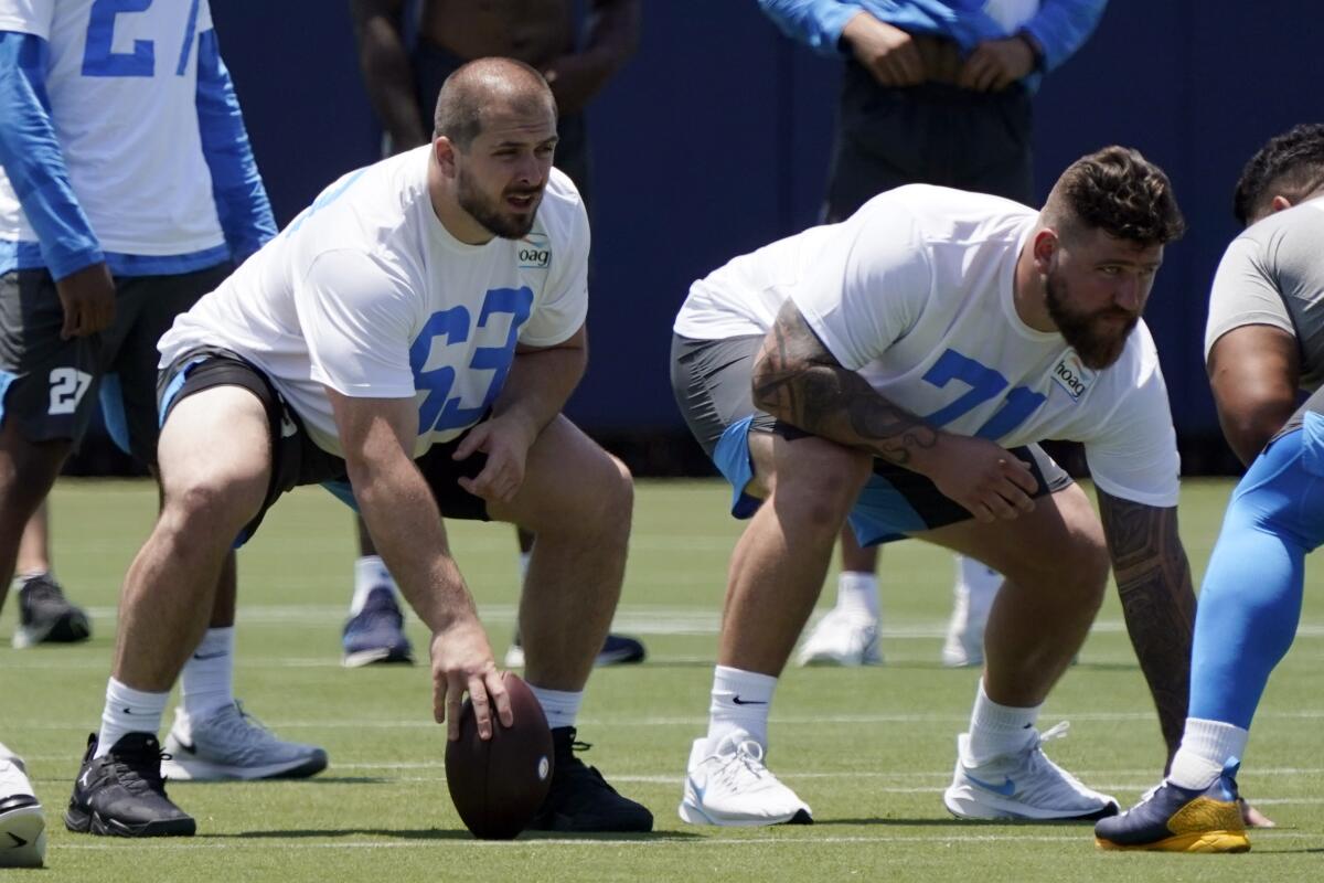 Chargers center Corey Linsley and guard Matt Feiler line up during practice in Costa Mesa. 