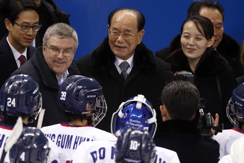 FILE - In this Feb. 10, 2018, file photo, IOC president Thomas Bach, second from left, and Kim Yo Jong, right, sister of North Korean leader Kim Jong Un, talks with players after the preliminary round of the women's hockey game between Switzerland and the combined Koreas at the 2018 Winter Olympics in Gangneung, South Korea. North Korea has decided not to participate in this year’s Olympic Games in Tokyo as it continues a self-imposed lockdown amid the coronavirus pandemic. A website run by the North's Sports Ministry said the decision was made during a national Olympic Committee meeting on March 25, 2021 where members prioritized protecting athletes from the “world public health crisis caused by COVID-19.” (AP Photo/Jae C. Hong, File)