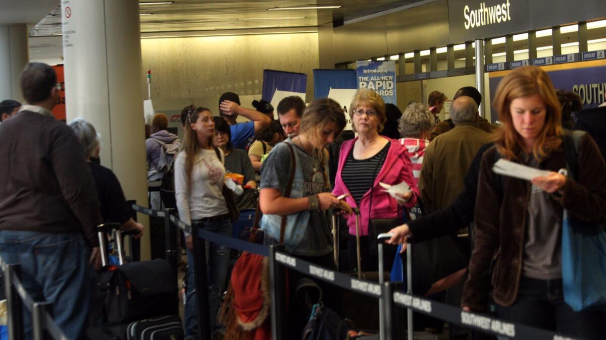 Thanksgiving travelers wait in line to check in at terminal one at the Los Angeles International Airport on Nov. 23, 2011. LAX had the highest rates of delays during the Thanksgiving holiday in 2016.
