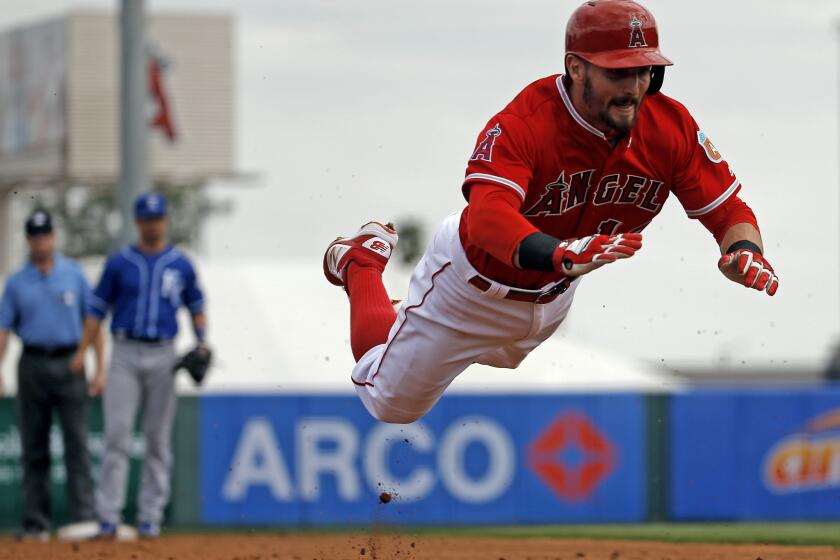 Angels second baseman Johnny Giavotella makes a head first dive for a triple during the second inning of a spring training game on Mar. 6.