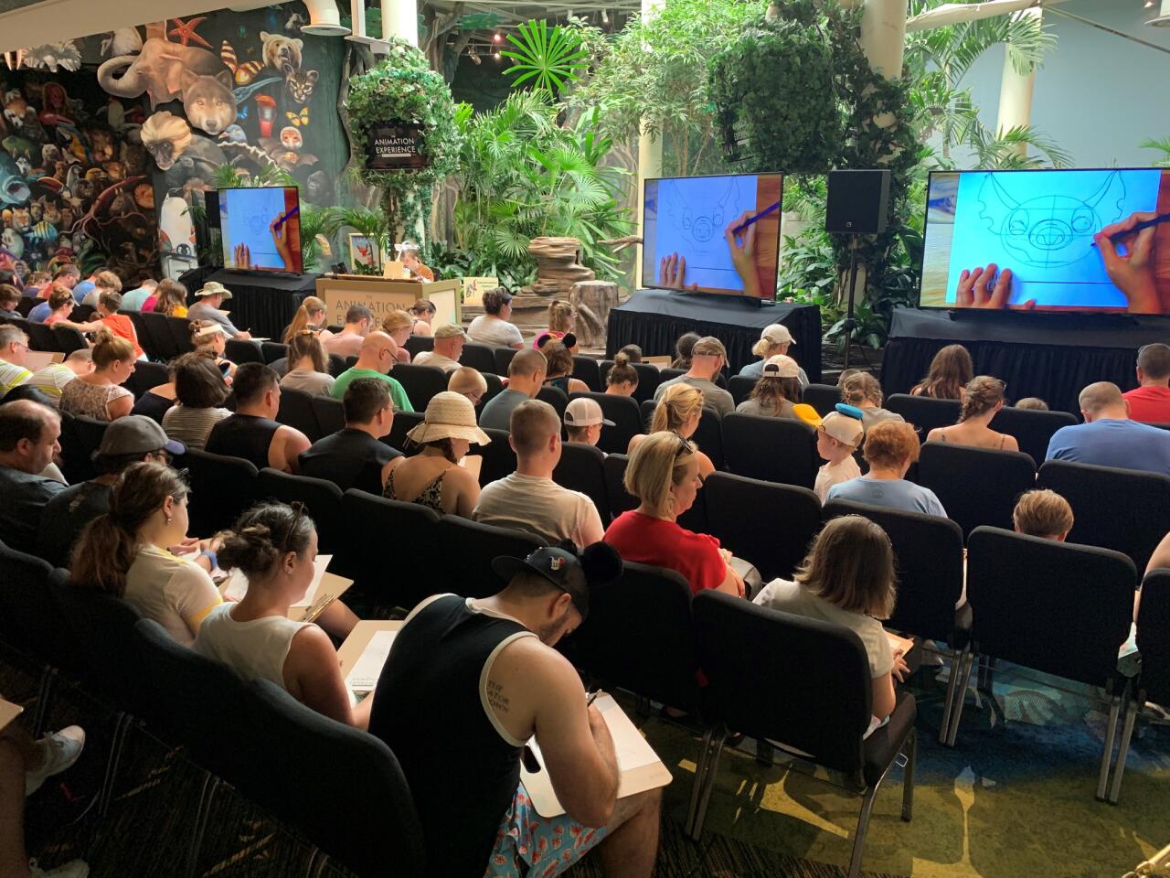 Visitors to Disney's Animal Kingdom theme park take part in the Animation Experience at Conservation Station, a new activity at the recently reopened Rafiki's Planet Watch at Walt Disney World.