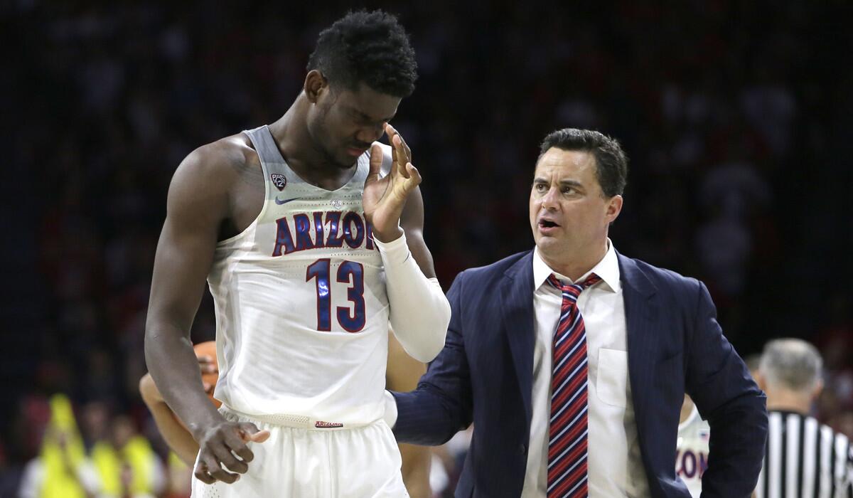 Arizona forward Deandre Ayton, left, and coach Sean Miller confer in the first half of a game against Stanford on March 1.