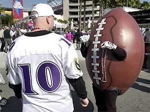 A large football mingles with the crowd outside Raymond James Stadium prior to Super Bowl XXXV.