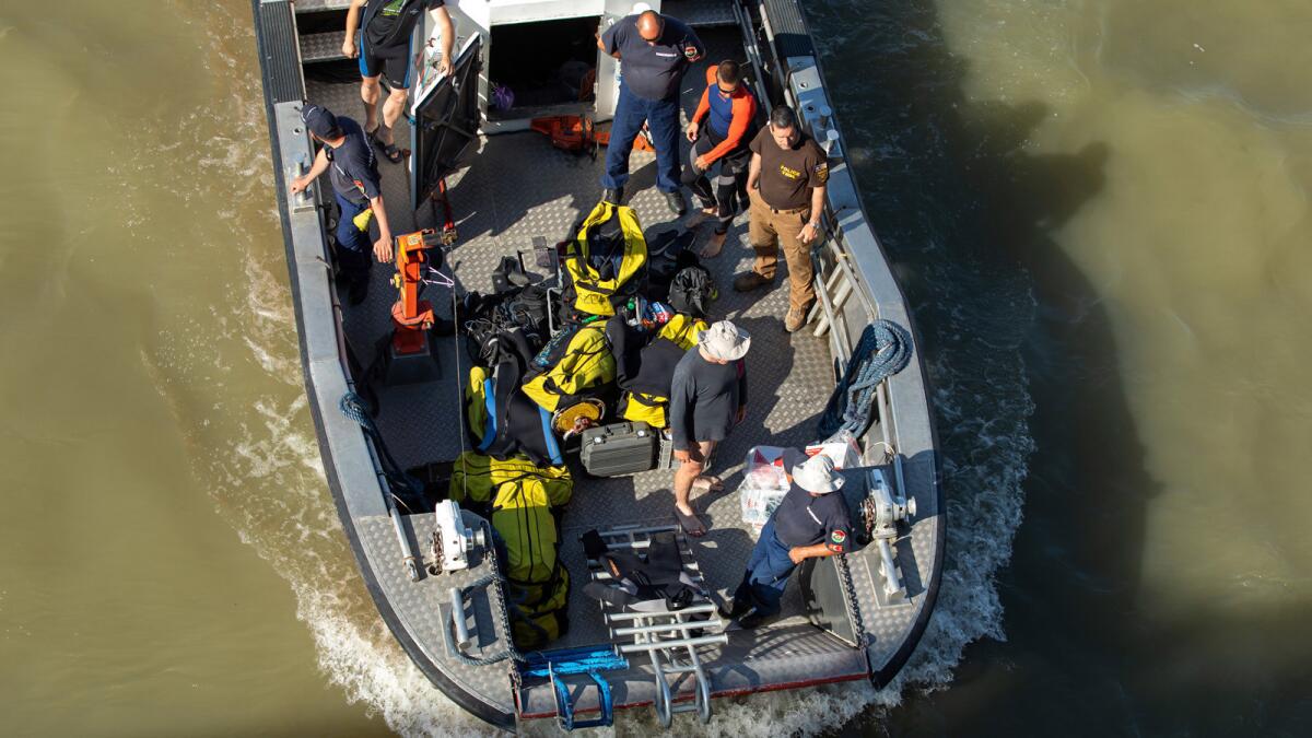 Divers work Saturday at Margit Bridge, scene of the deadly boat accident in Budapest, Hungary.