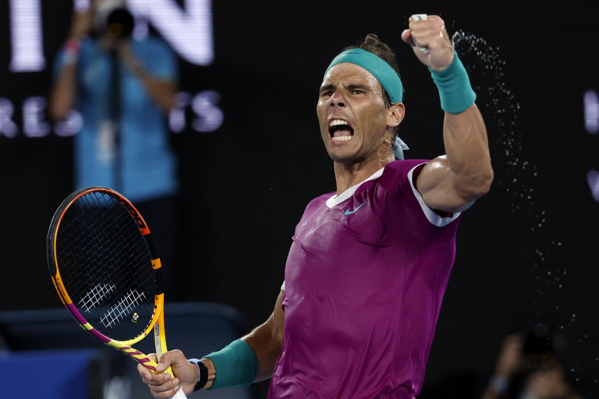 Rafael Nadal raises his hand in victory at the Australian Open.