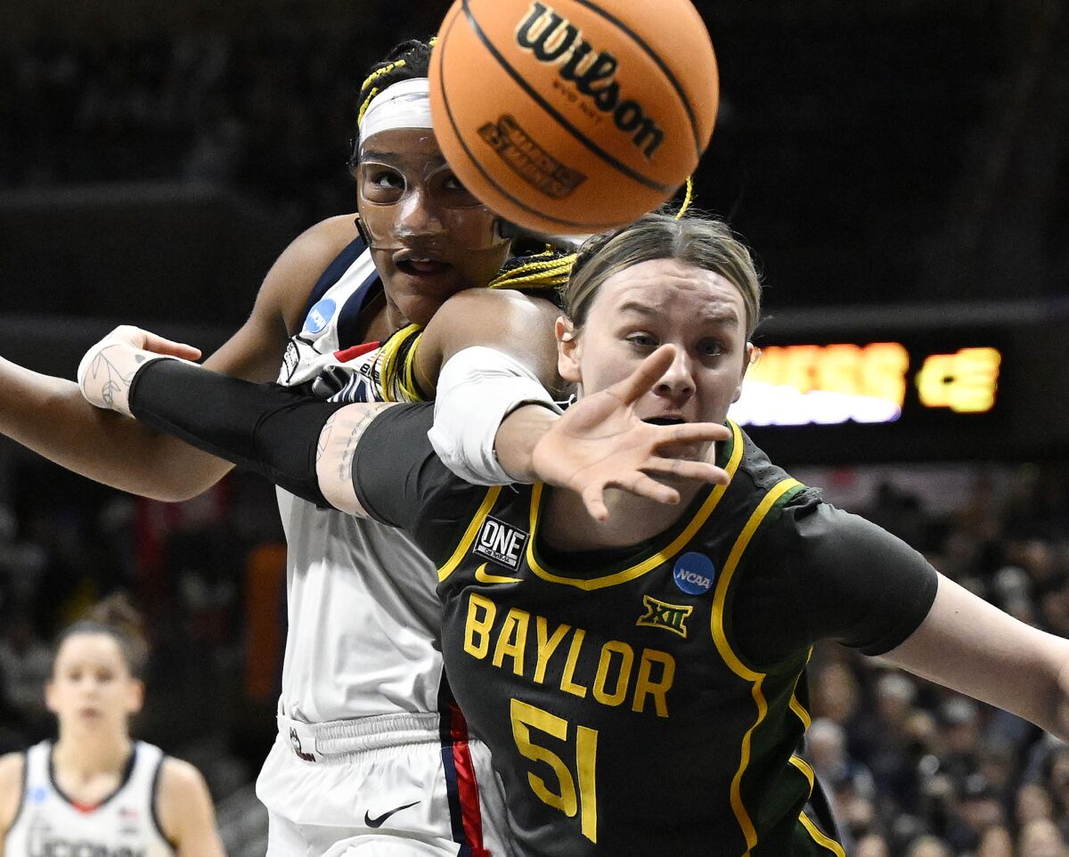 UConn's Aaliyah Edwards, top, reaches over Baylor's Caitlin Bickle (51) in the first half of a second-round college basketball game in the NCAA Tournament, Monday, March 20, 2023, in Storrs, Conn. (AP Photo/Jessica Hill)