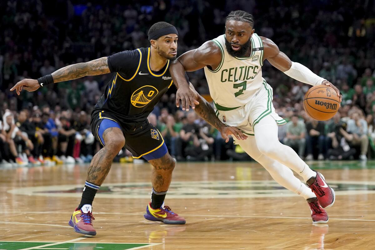 Boston Celtics guard Jaylen Brown drives against Golden State Warriors guard Gary Payton II.