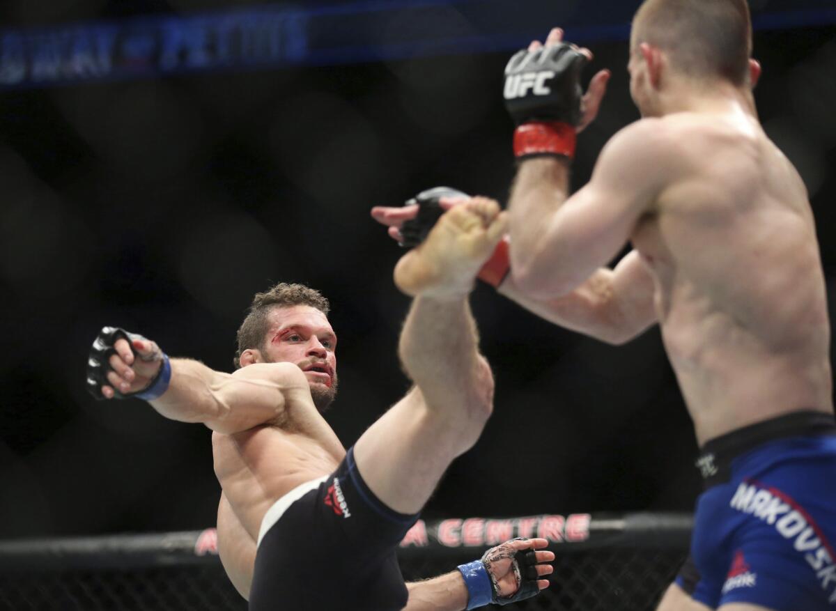 Dustin Ortiz, left, attempts to kick Zach Makovsky during a flyweight fight in Toronto.