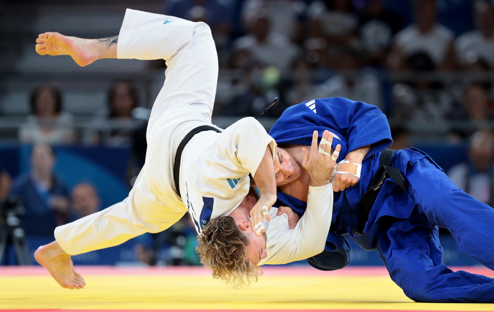 Canada's Francois Gauthier-Drapeau, blue takes down Italy's Antonio Esposito in the men's 81kg category on Tuesday. 