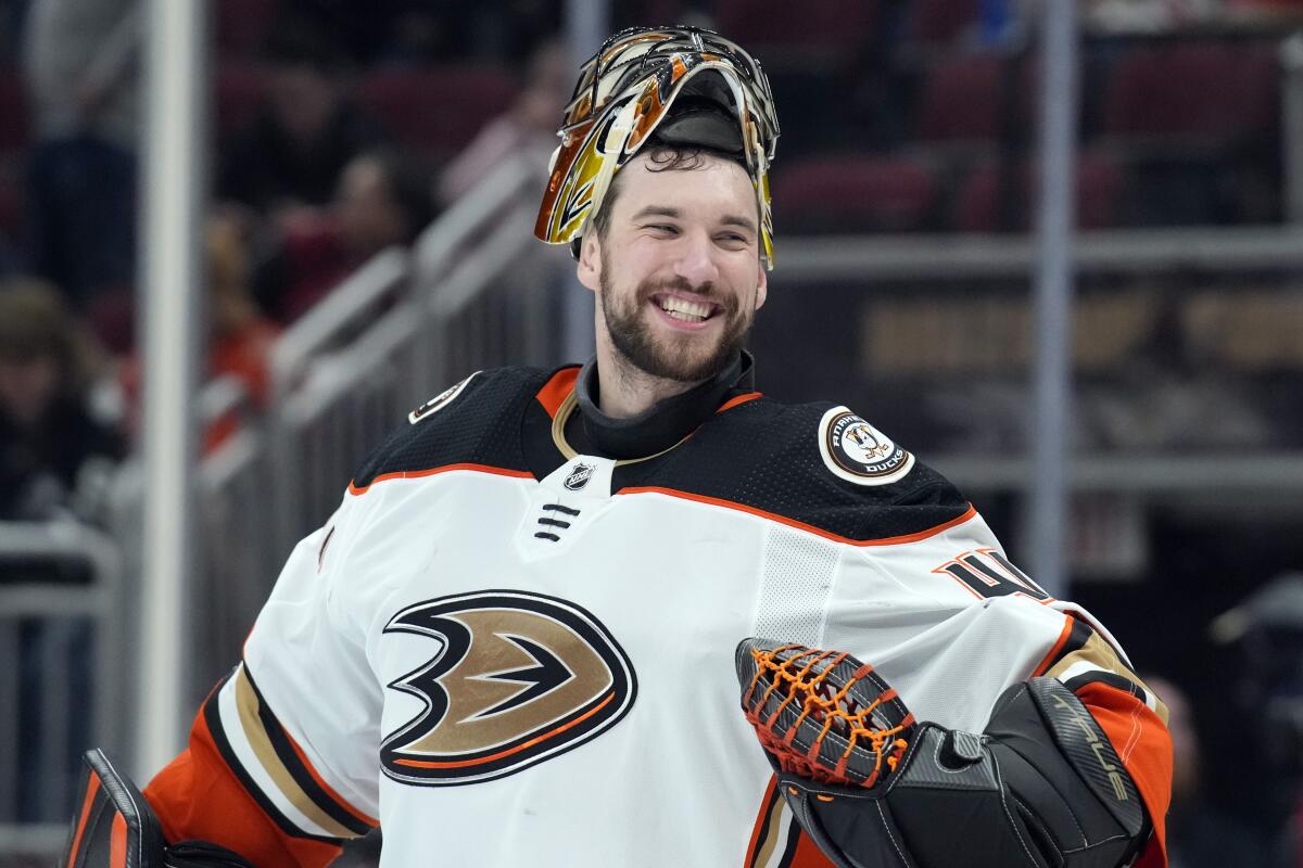Ducks goalie Anthony Stolarz jokes with the referees during the second period April 1, 2022.