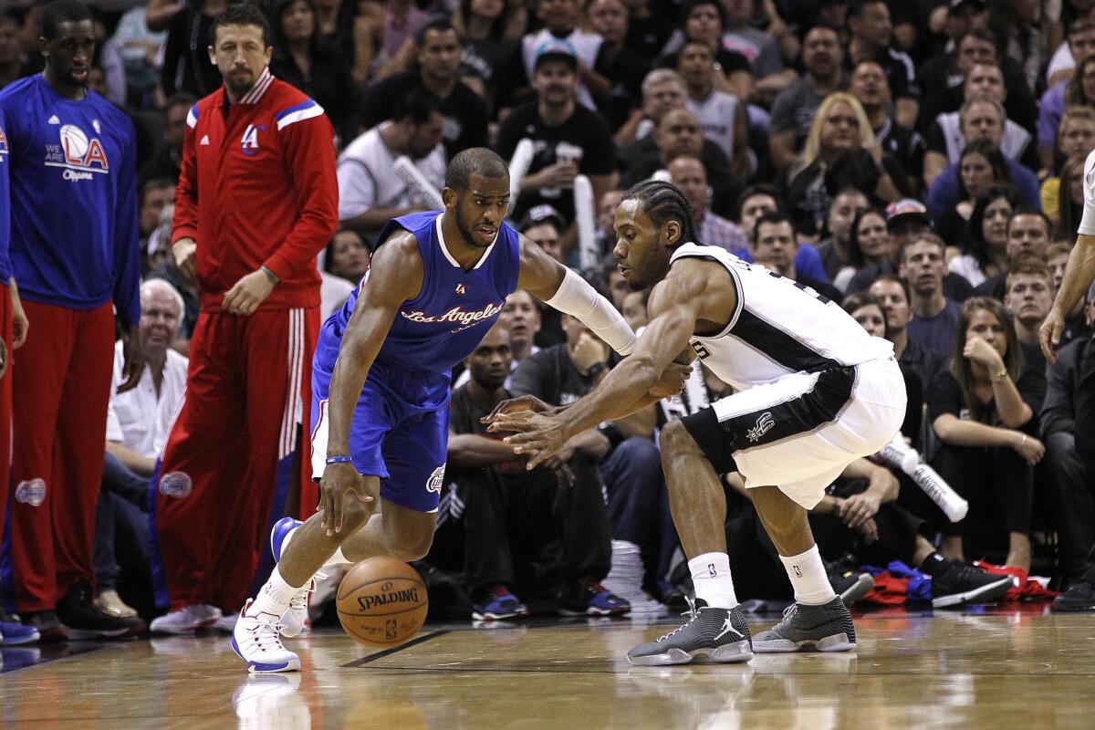 Point guard Chris Paul of the Clippers drives around Spurs forward Kawhi Leonard in the first half of the Clippers' Game 6 victory.