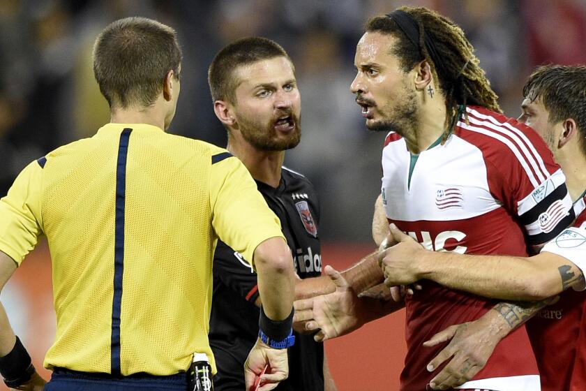 Revolution midfielder Jermaine Jones is restrained by teammate Kelyn Rowe and D.C. United midfielder Perry Kitchen after he was given a red card and ejected during the second half Wednesday.