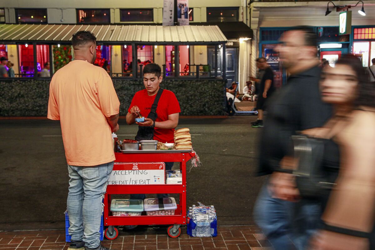Street vendors sell food along 5th avenue and Market Street in the Gaslamp Quarter on Saturday, August 27, 2021.