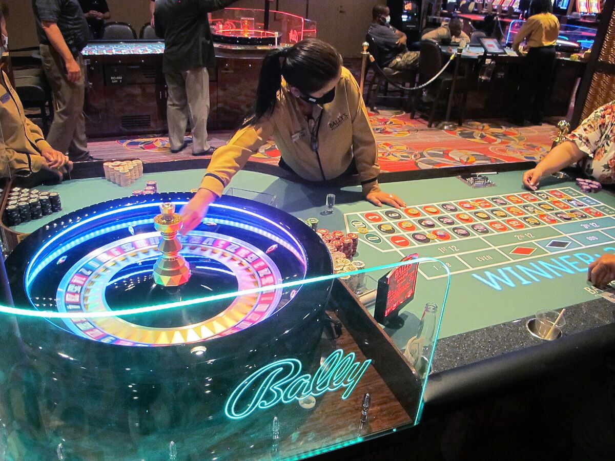 This June 23, 2021 photo shows a dealer conducting a game of roulette at Bally's casino in Atlantic City, N.J. Figures released Nov. 9, 2021 from the American Gaming Association show the nation's commercial casinos won nearly $14 billion in the third quarter of this year, marking the best three-month period in history for the industry, which is poised to have its best full year ever in 2021. (AP Photo/Wayne Parry)