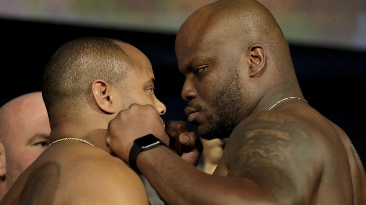 Daniel Cormier, left, and Derrick Lewis square off for photographers Friday during the weigh-ins for their UFC 230 bout at Madison Square Garden in New York.